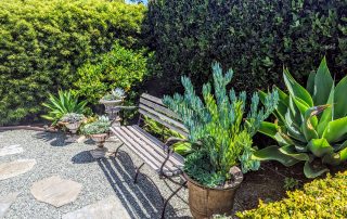 Bench with potted plants at the 2022 Gate and Garden Tour