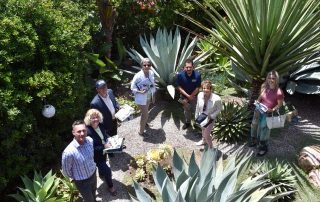 Oranizers of the 2022 Gate in Garden Tour standing in a featured garden with succulents