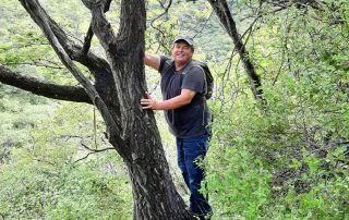 Image of Kelly Griffin hugging a tree