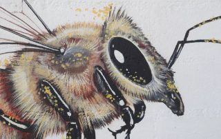 Detail of the Matt Willey "For the Good of the Hive Mural" showing a closeup of one of the bees in the mural.