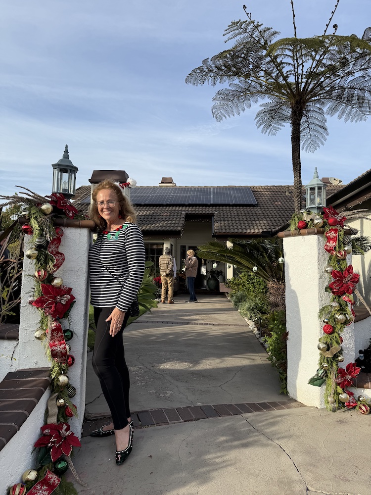 L Goodlad front house Home owner greets members at her gate at the Holiday Member's Home Tour.